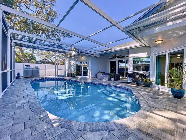 an aerial view of residential houses with outdoor space and swimming pool
