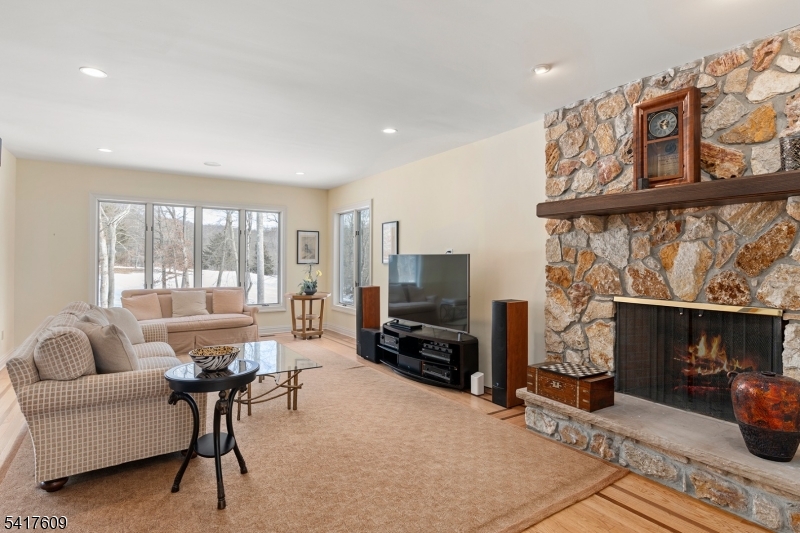 2 Cobblefield Road Mendham, NJ 07945 - Photo 8 of 50 a living room with furniture a fireplace and a large window