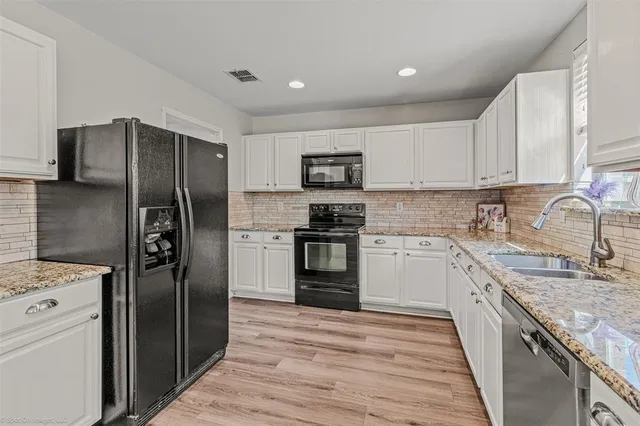 a kitchen with a refrigerator sink and microwave