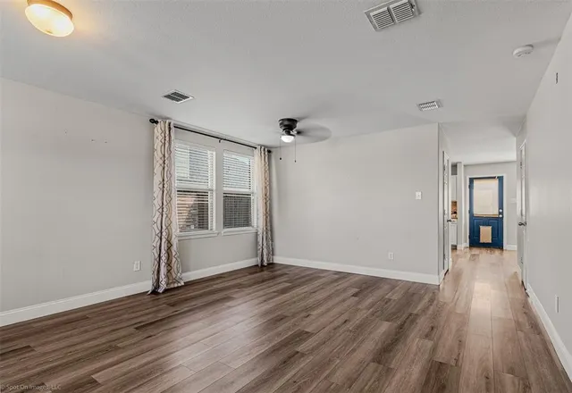 wooden floor in an empty room with a window