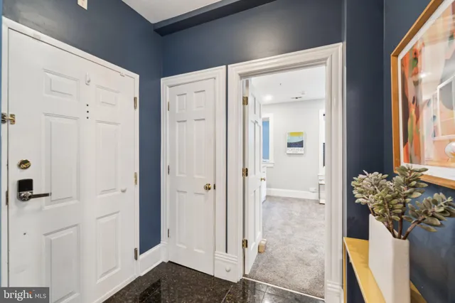 a view of a hallway with wooden floor and a mirror