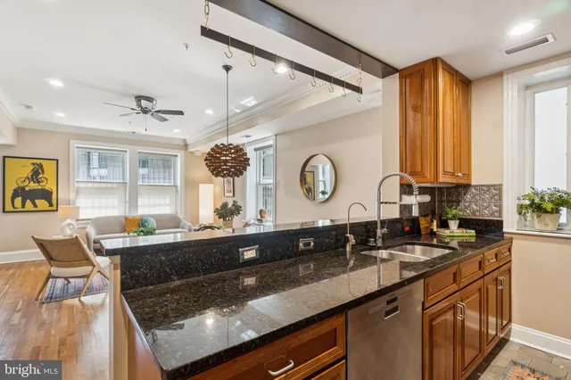 a kitchen with a sink cabinets and window