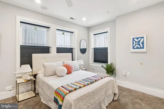 a bedroom with a bed and window