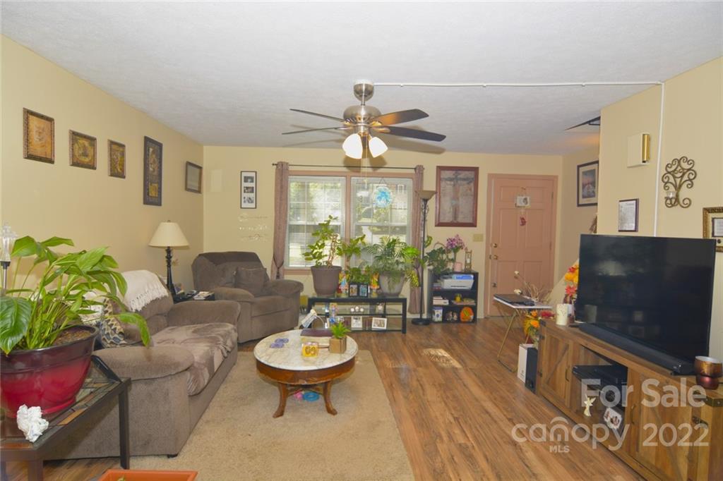 101 Boyd Drive, Unit 2B Flat Rock, NC 28731 - Photo 3 of 11 a living room with furniture a flat screen tv and a dining table