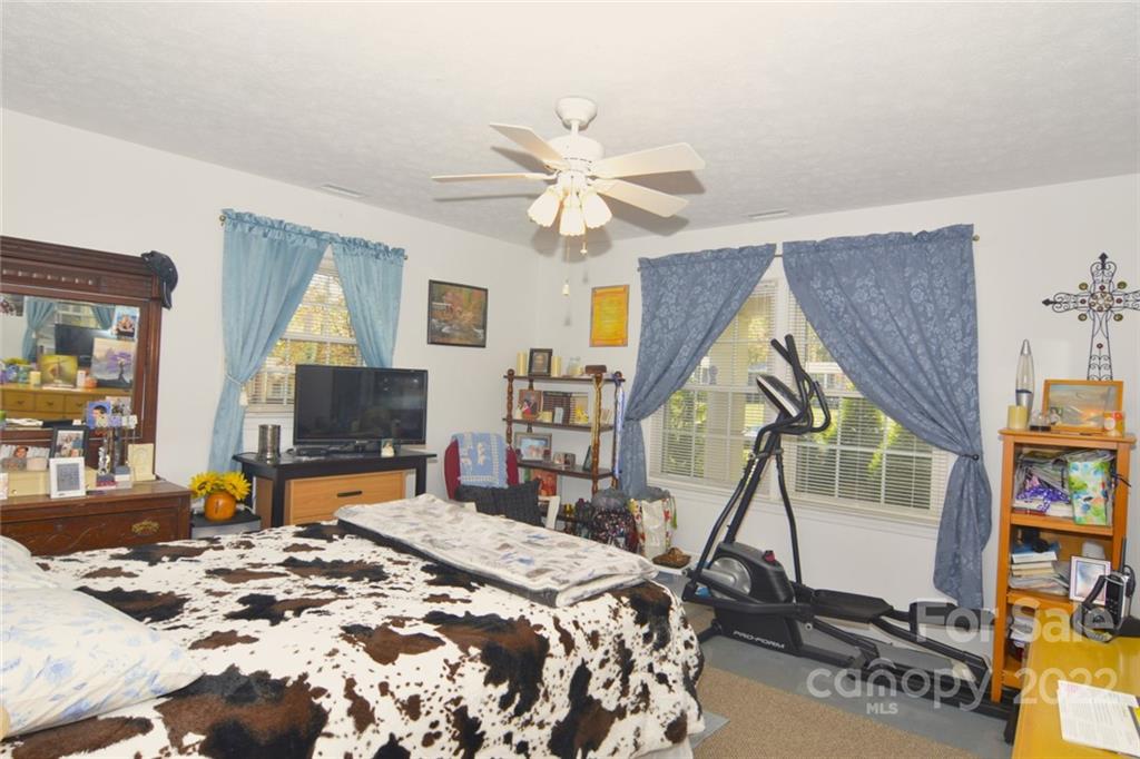 101 Boyd Drive, Unit 2B Flat Rock, NC 28731 - Photo 6 of 11 a bedroom with a bed and a flat screen tv