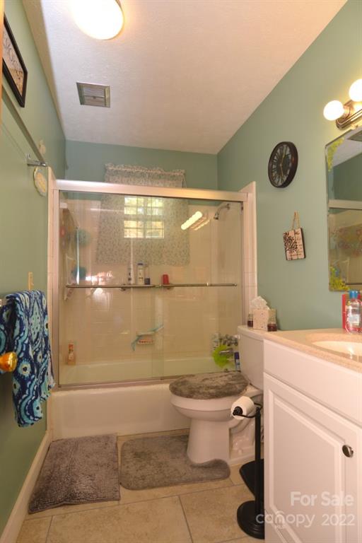 101 Boyd Drive, Unit 2B Flat Rock, NC 28731 - Photo 9 of 11 a bathroom with a sink toilet and shower