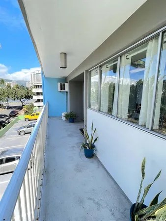 a view of a hallway with a potted plant on a patio