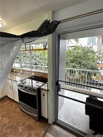 a kitchen with a stove and a wooden floor