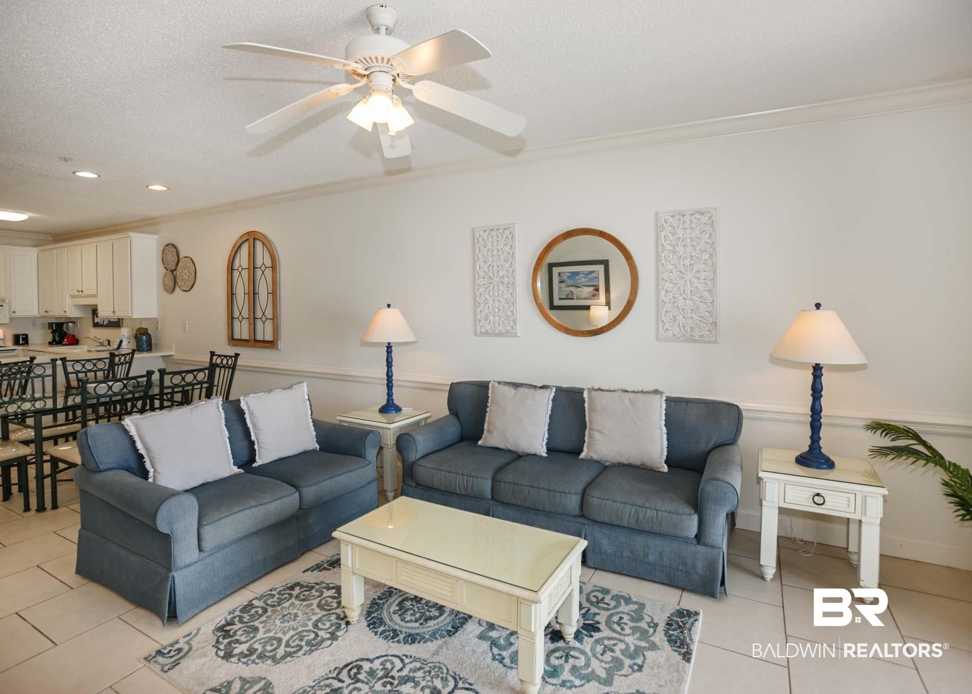 28910 Perdido Beach Boulevard, Unit 4B Orange Beach, AL 36561 - Photo 18 of 48 Living room with a ceiling fan, light tile patterned floors, ornamental molding, and a textured ceiling