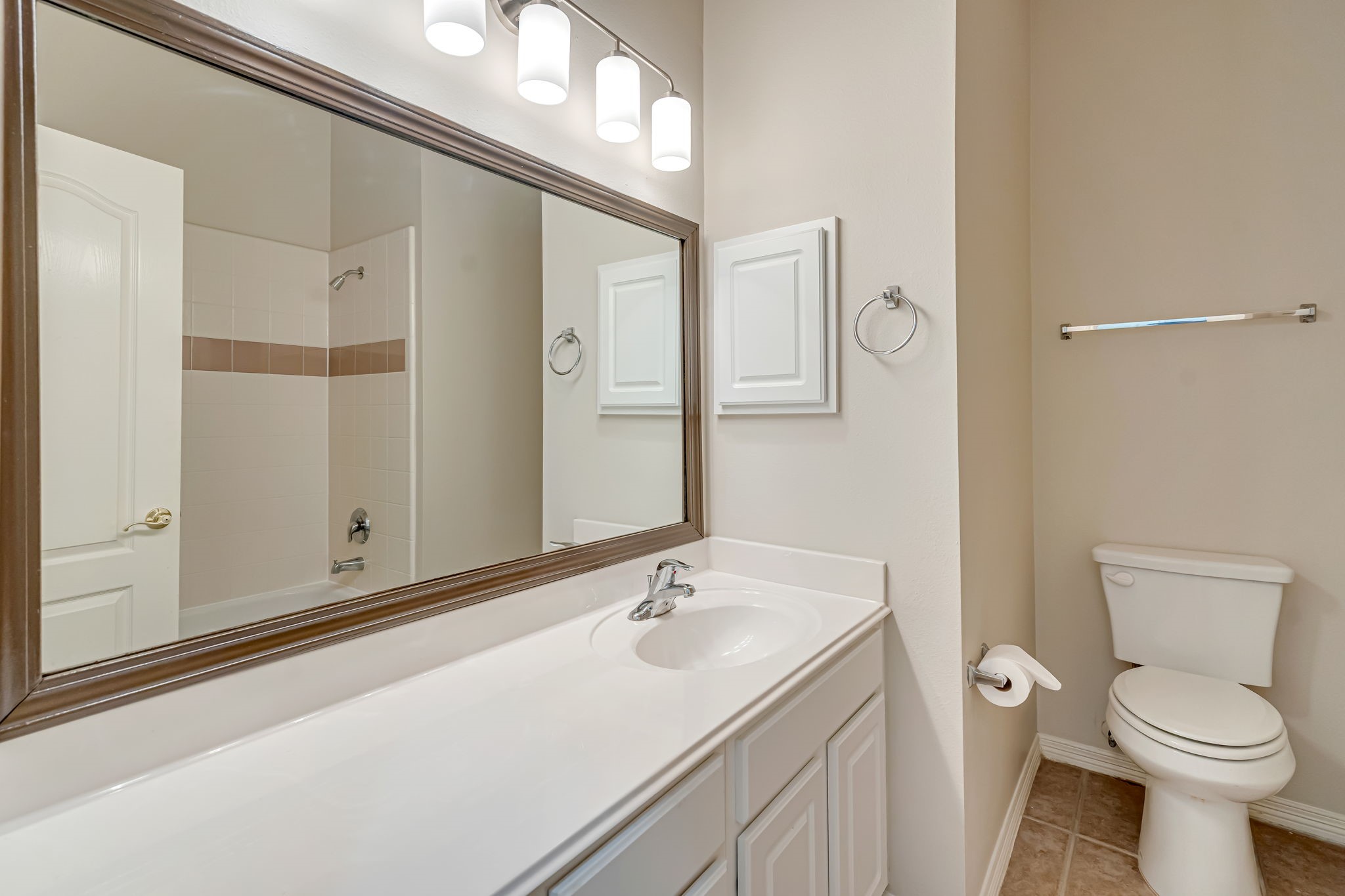 24919 Corbin Gate Drive Spring, TX 77389 - Photo 20 of 31 a bathroom with a sink a toilet and a mirror