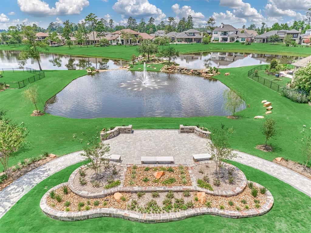 24919 Corbin Gate Drive Spring, TX 77389 - Photo 28 of 31 a view of a lake with a yard and large trees