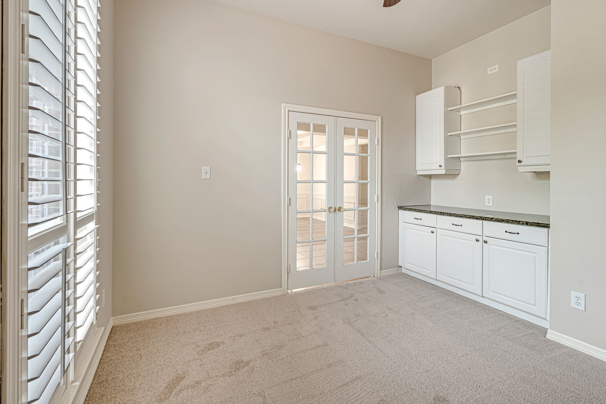 24919 Corbin Gate Drive Spring, TX 77389 - Photo 10 of 31 a view of a kitchen with white cabinets and a window