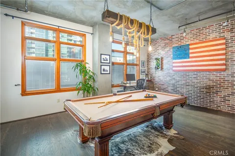 a room with pool table and windows