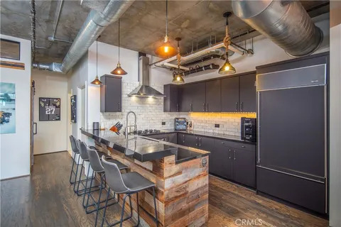 a kitchen with a sink and chairs