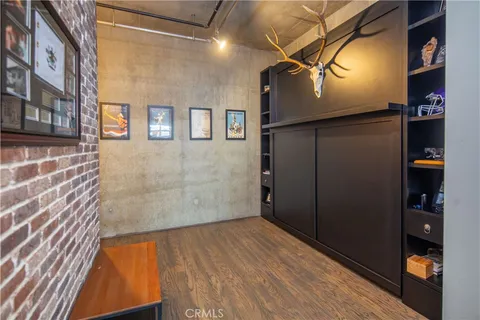 a bedroom with a bed and painting on the wall