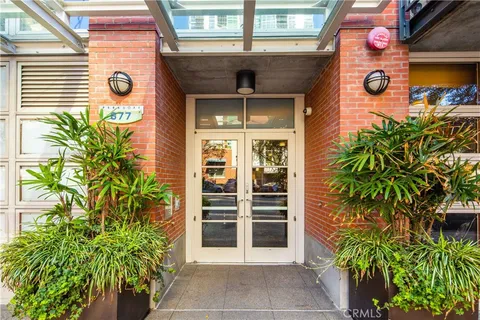 a dining room with furniture and a potted plant