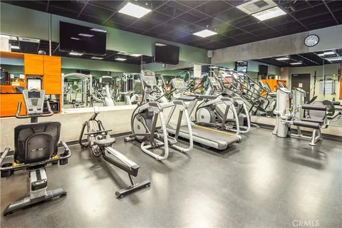 a view of a patio with dining table and chairs under an umbrella