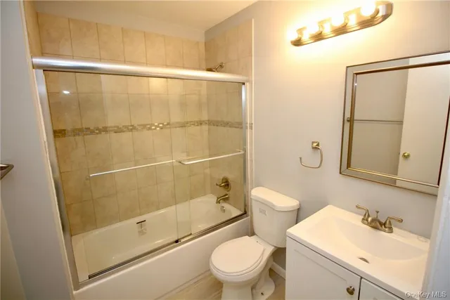 a bathroom with a shower a toilet and sink