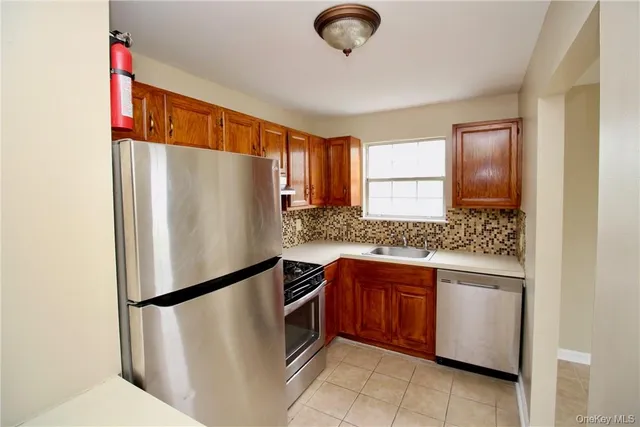 a white refrigerator freezer sitting inside of a kitchen