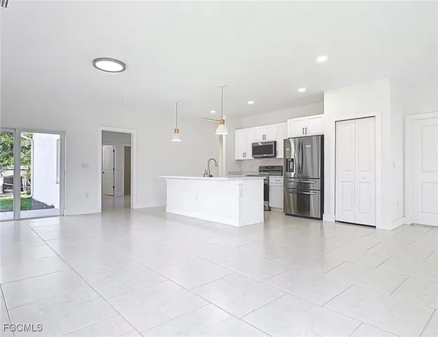 a kitchen with stainless steel appliances a refrigerator sink and cabinets