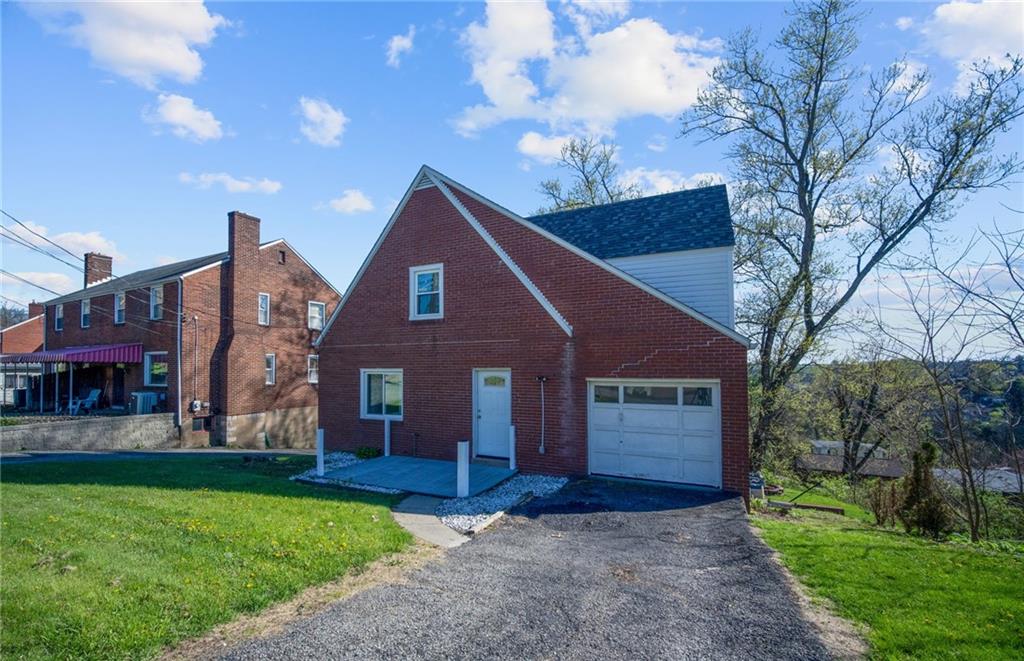 4030 Lebanon Church Road West Mifflin, PA 15122 - Photo 39 of 45 a view of a brick house with a yard