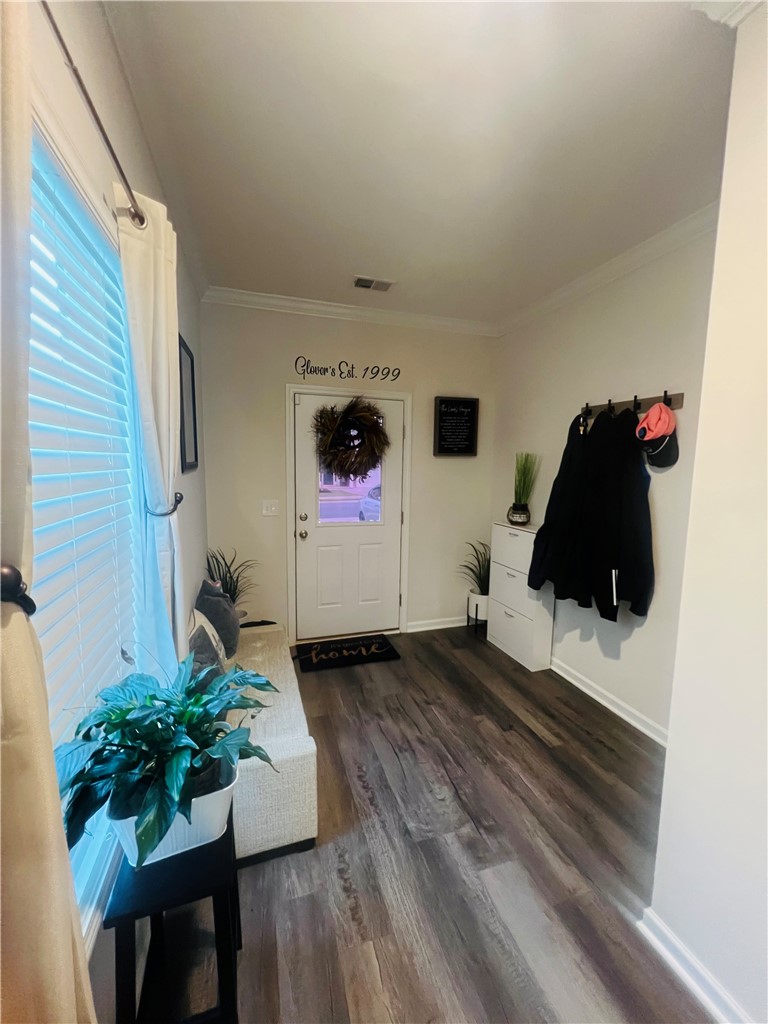 234 Samuel Street Pendleton, SC 29670 - Photo 2 of 17 A welcoming entry foyer features rich wood-look flooring and a functional coat rack.