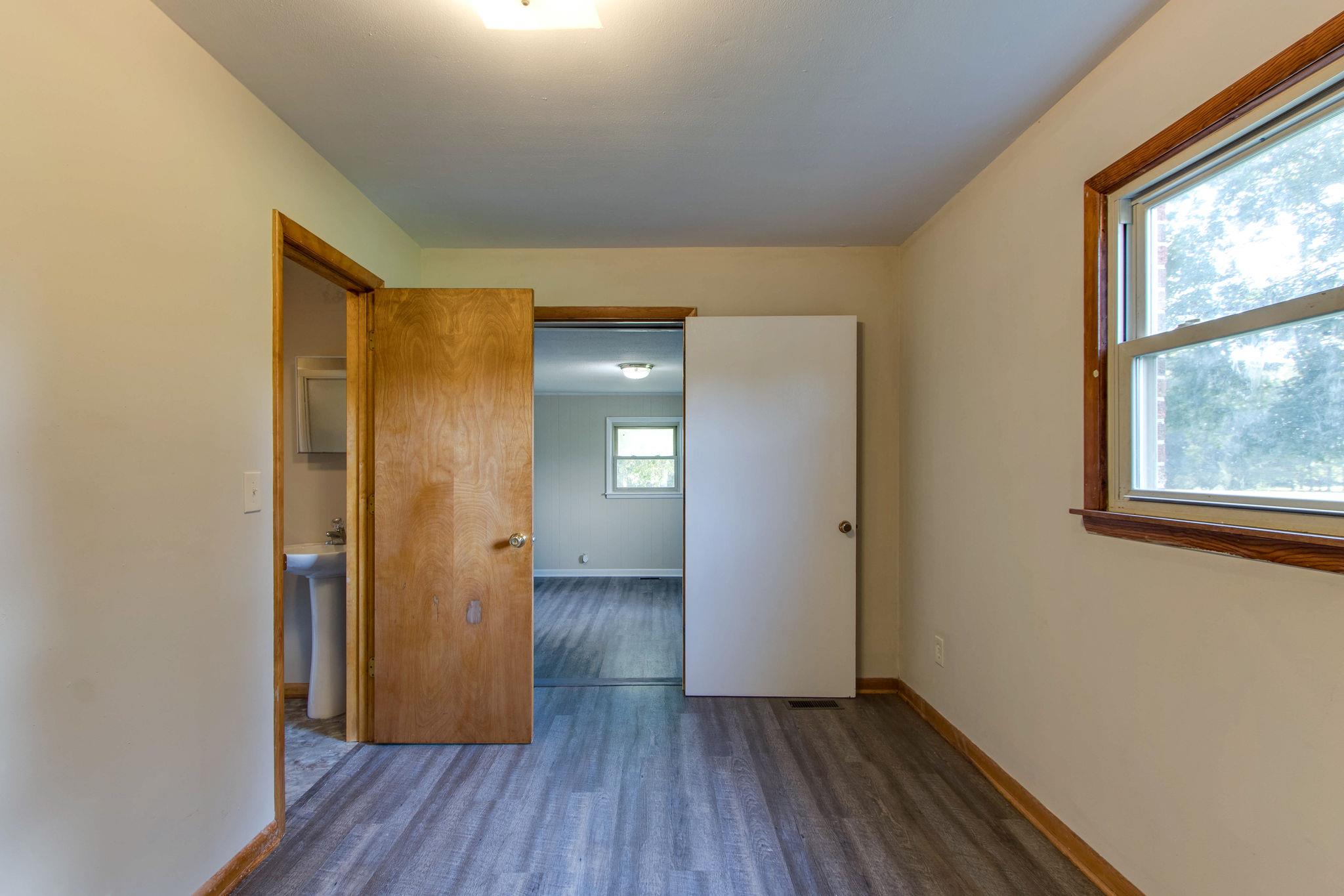 403 Park Creek Road Manchester, TN 37355 - Photo 13 of 24 an empty room with wooden floor and windows