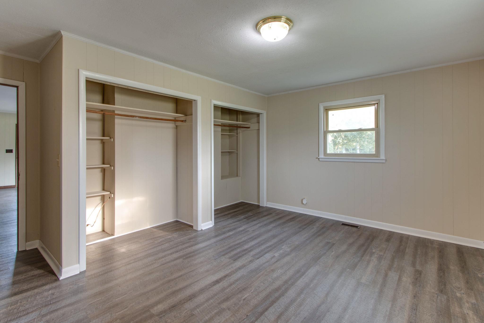 403 Park Creek Road Manchester, TN 37355 - Photo 15 of 24 an empty room with wooden floor and windows
