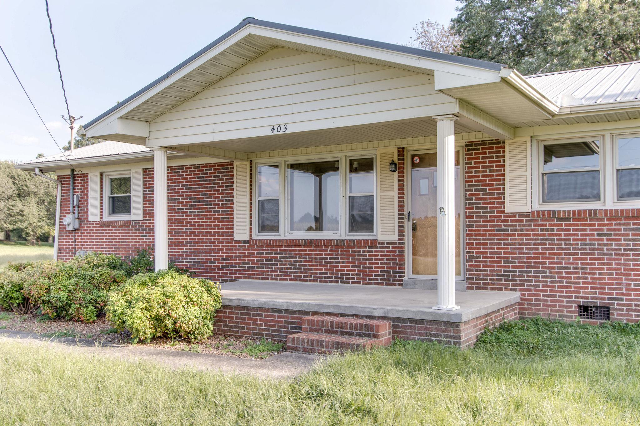 403 Park Creek Road Manchester, TN 37355 - Photo 2 of 24 a front view of a house with a garden