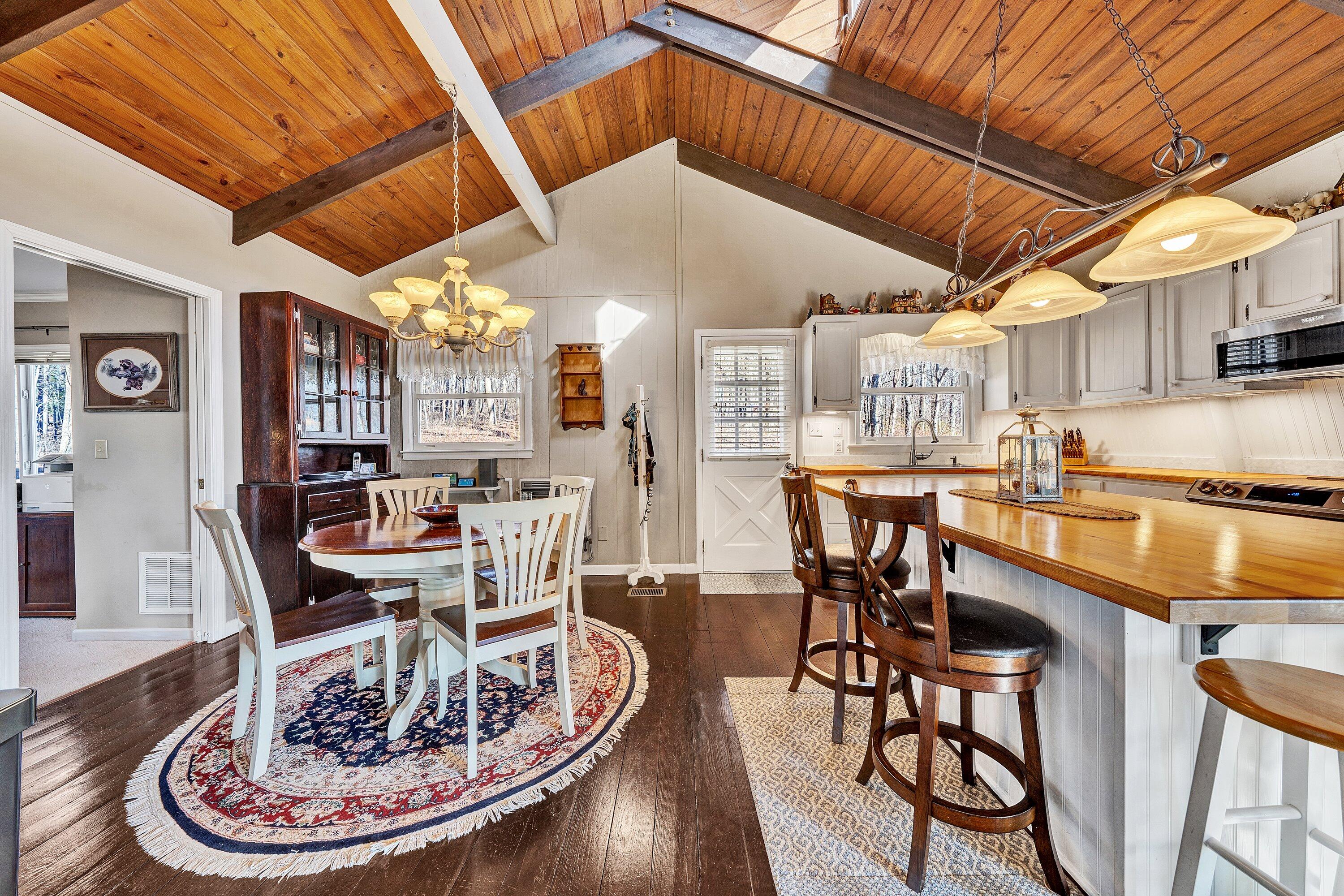 1575 Walnut Knob Road Floyd, VA 24091 - Photo 18 of 62 a dining room with furniture a kitchen and chandelier