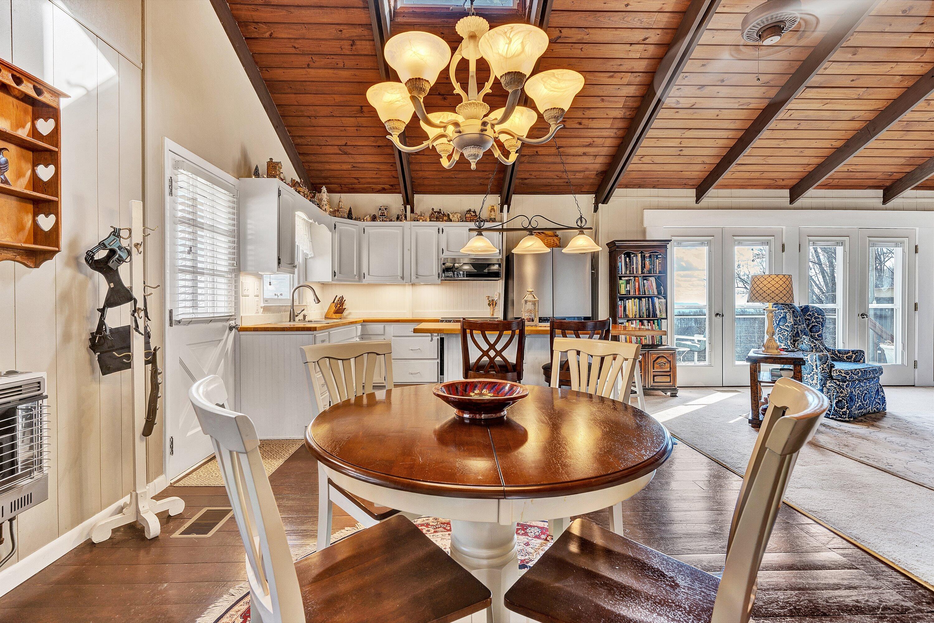 1575 Walnut Knob Road Floyd, VA 24091 - Photo 21 of 62 a view of a dining room with furniture and chandelier