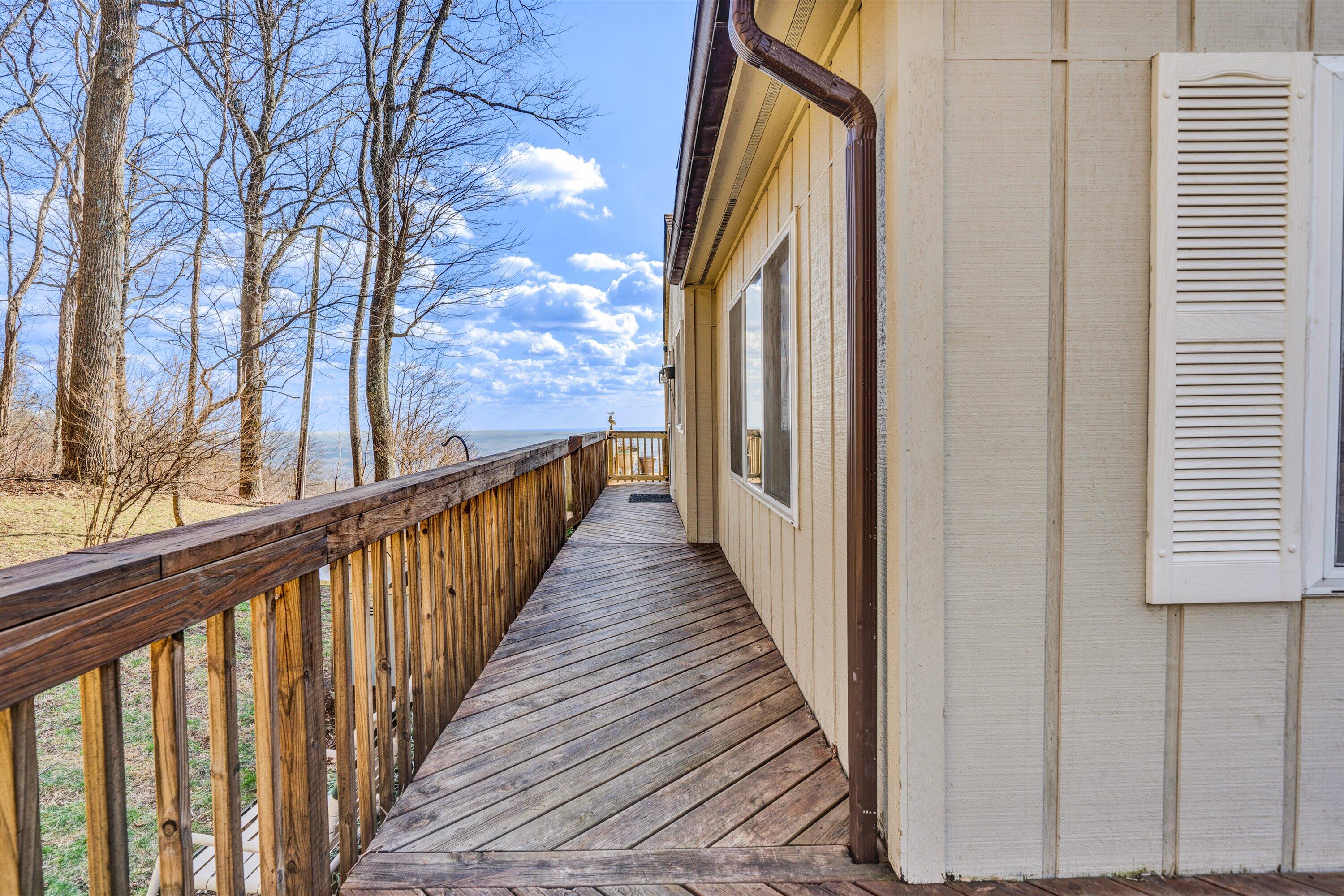 1575 Walnut Knob Road Floyd, VA 24091 - Photo 7 of 62 a view of a balcony with wooden floor and fence