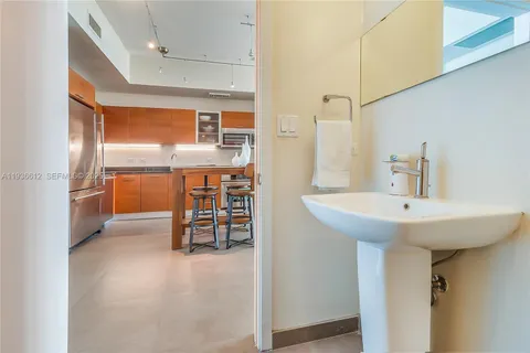 a kitchen with stainless steel appliances a sink and a refrigerator