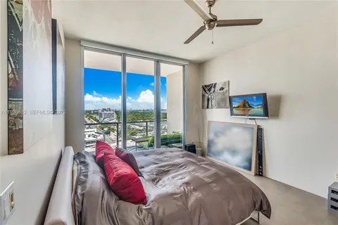 a bed sitting in a bedroom next to a window
