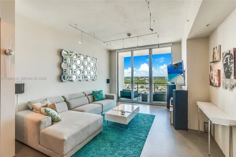 a living room with furniture and a chandelier