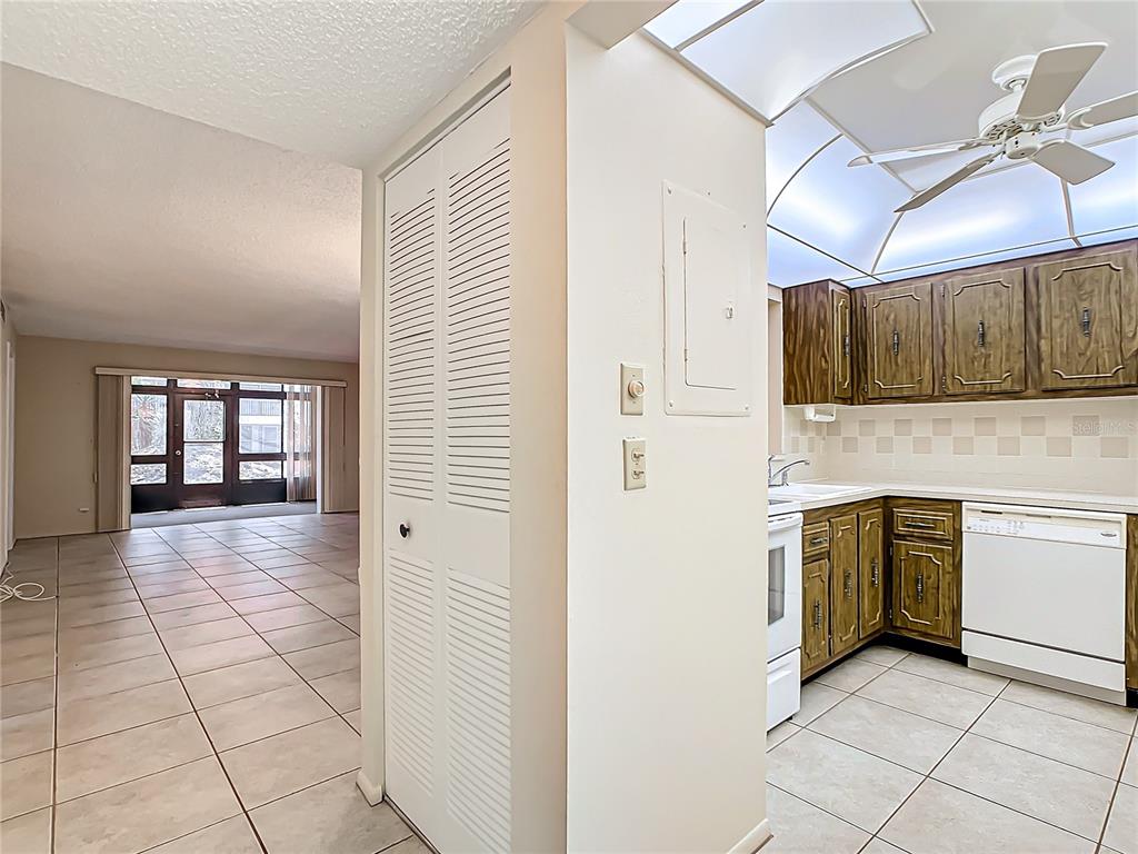 11485 Oakhurst Road, Unit 107 Largo, FL 33774 - Photo 11 of 60 a kitchen with stainless steel appliances granite countertop a stove a sink and a refrigerator