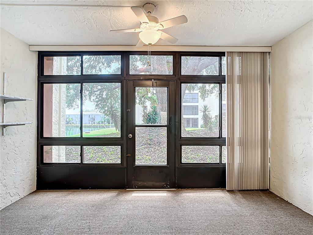 11485 Oakhurst Road, Unit 107 Largo, FL 33774 - Photo 24 of 60 a living room with a large window