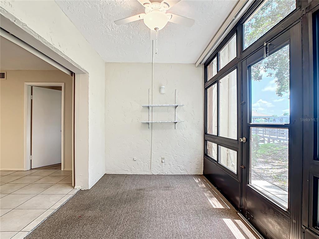 11485 Oakhurst Road, Unit 107 Largo, FL 33774 - Photo 26 of 60 a view of empty room with cabinet and floor to ceiling window
