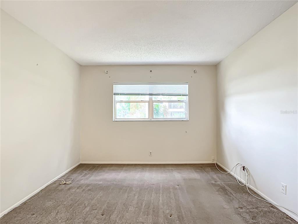 11485 Oakhurst Road, Unit 107 Largo, FL 33774 - Photo 28 of 60 an empty room with a window