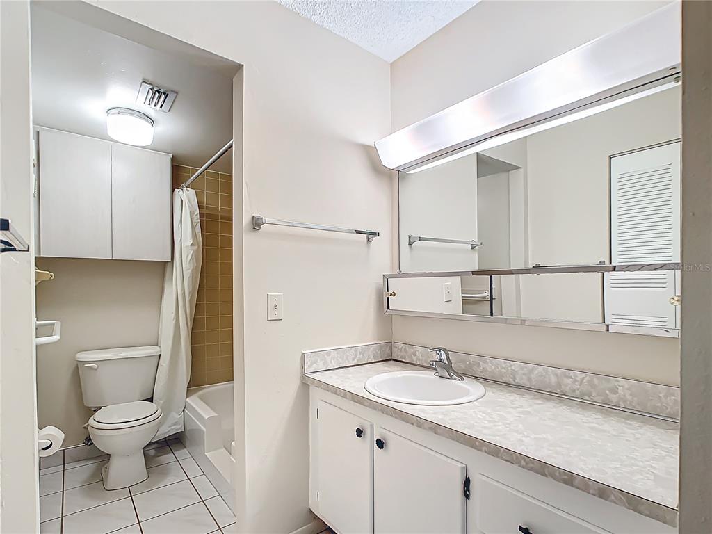 11485 Oakhurst Road, Unit 107 Largo, FL 33774 - Photo 33 of 60 a bathroom with a sink a toilet and shower
