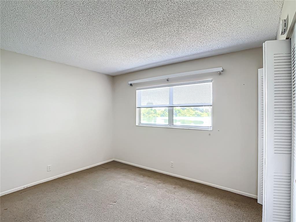 11485 Oakhurst Road, Unit 107 Largo, FL 33774 - Photo 37 of 60 an empty room with a window