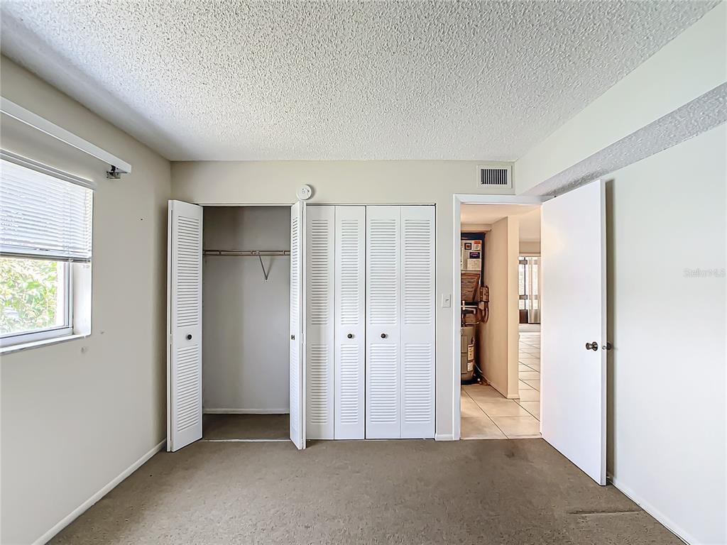 11485 Oakhurst Road, Unit 107 Largo, FL 33774 - Photo 39 of 60 an empty room with windows and closet