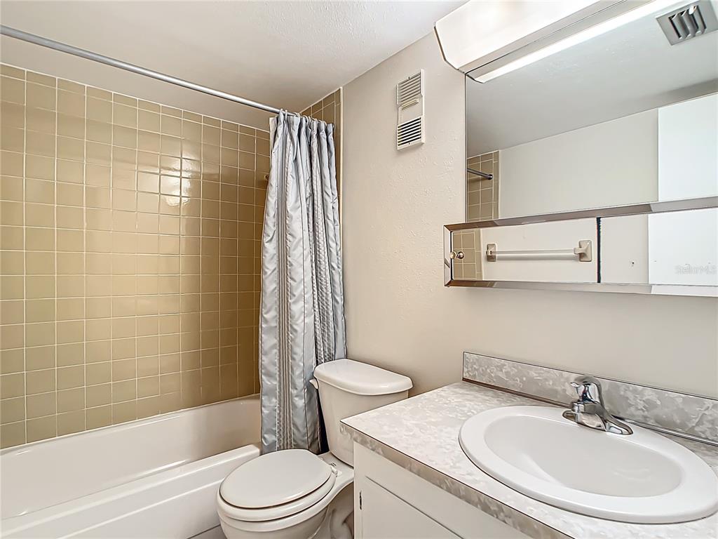 11485 Oakhurst Road, Unit 107 Largo, FL 33774 - Photo 41 of 60 a bathroom with a sink toilet and shower