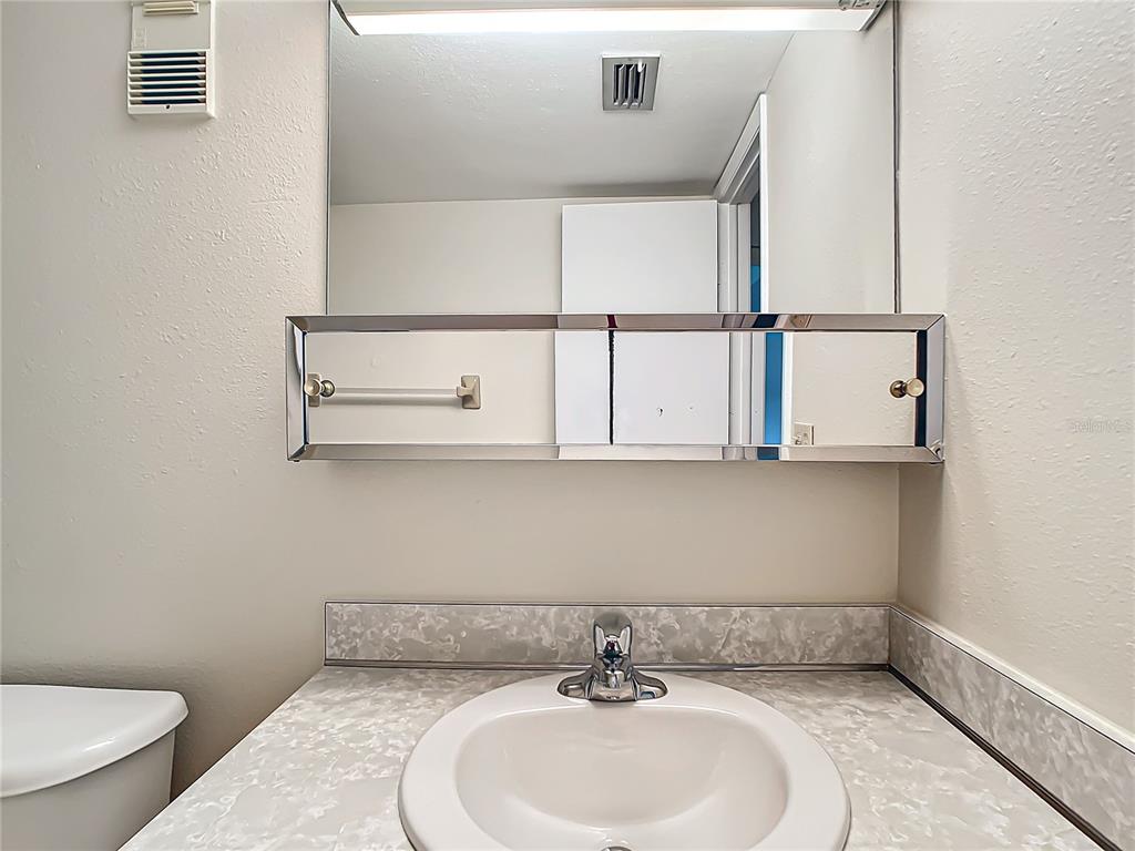 11485 Oakhurst Road, Unit 107 Largo, FL 33774 - Photo 42 of 60 a bathroom with a sink and a toilet