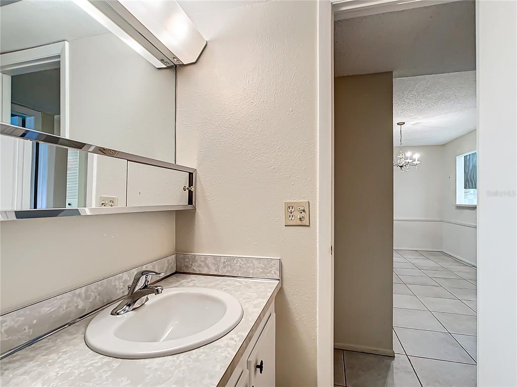 11485 Oakhurst Road, Unit 107 Largo, FL 33774 - Photo 44 of 60 a bathroom with a sink and a mirror