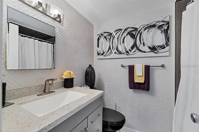 a living room with furniture a piano and a flat screen tv