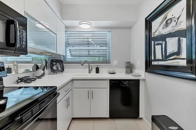 a kitchen with a sink and white stainless steel appliances