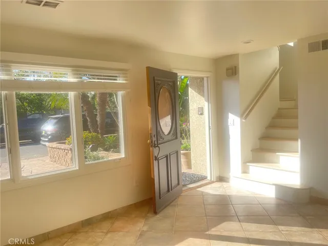 a view of an empty room with a fireplace and a window