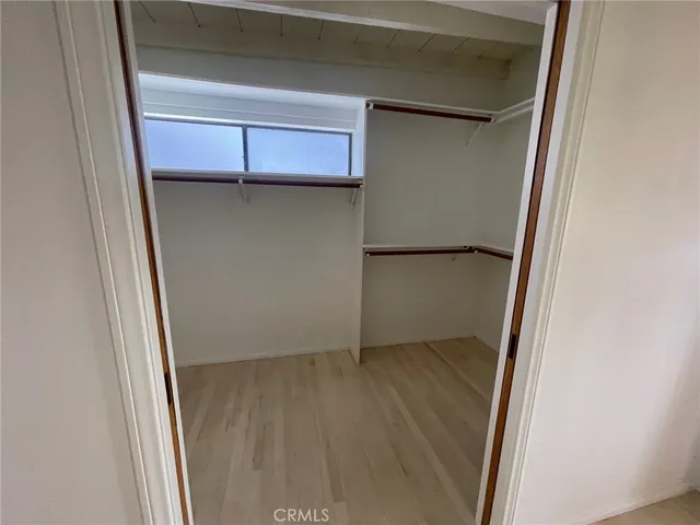 a view of a hallway with wooden floor and entryway