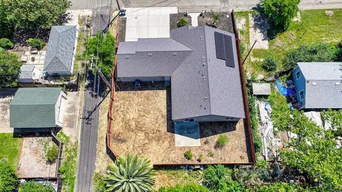 an aerial view of a house with a yard and garden